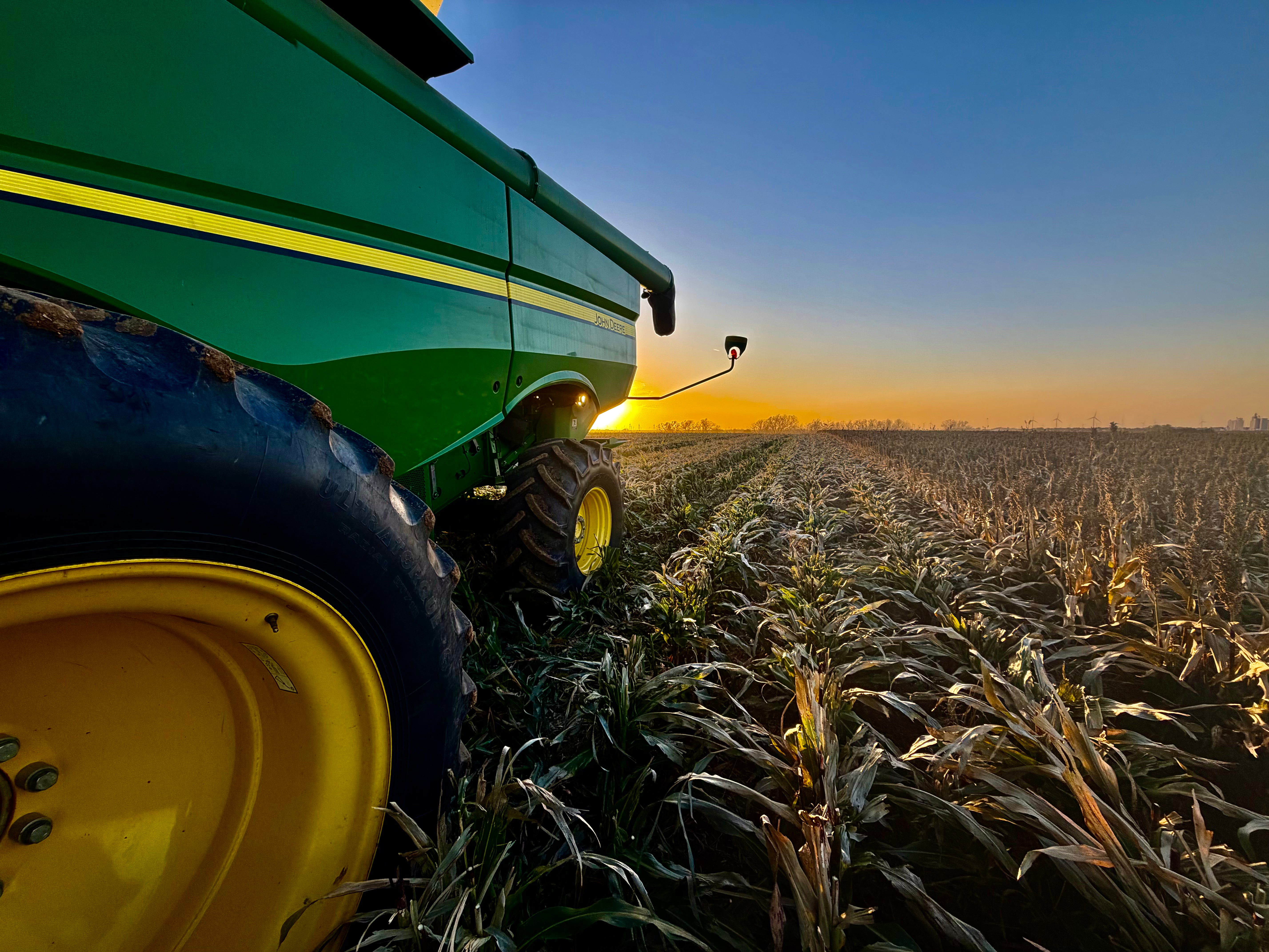 John Deere tractor in a field at sunset on Stegman Family Farms